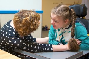 Girl with disability communicating with carer